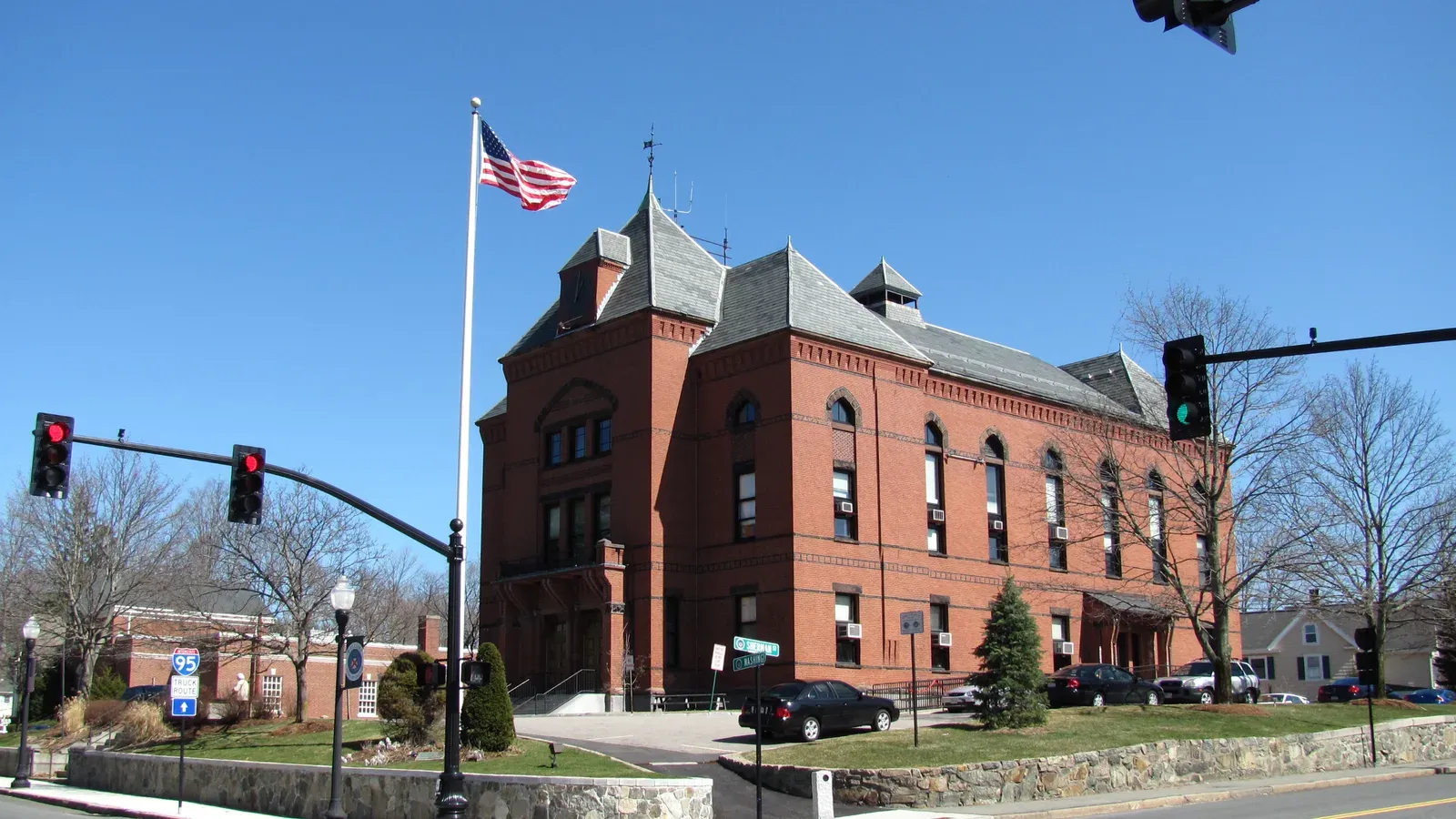Canton Town Hall, a red-brick Victorian building with steep slate roofs on a corner in the town center, Canton, Massachusetts